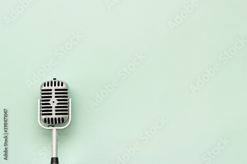 Vintage retro style silver microphone, top view, copy space