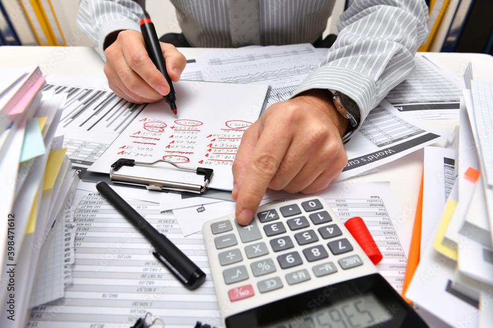 business concept - businessman working with reports in office, table and workspace close view, analyzing financial data, writes and counts business concept - businessman working with reports in office, table and workspace close view, analyzing financial data, writes and counts