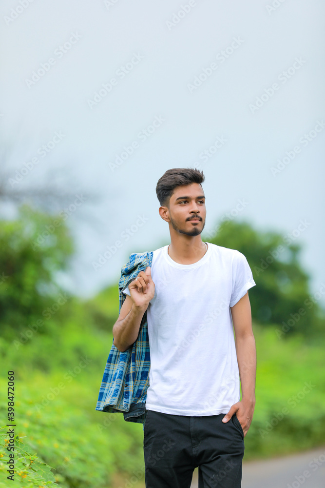 Young indian man showing expression over nature background Young indian man showing expression over nature background