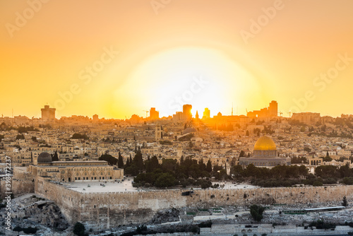  Old city of Jerusalem on the temple mount under golden sunset in the evening with golden dome of the rock, Al-aqsa mosque, sunset view from the Mount of Olives
