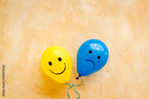 Fototapeta Emotions concept - happiness and sadness on the colored ballons