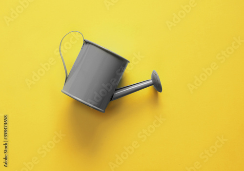 Watering can on trendy colorful background. photo
