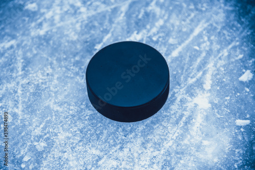 hockey puck lies on the snow macro