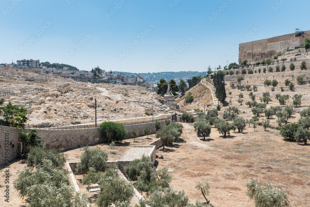 The Kidron Valley,on the eastern side of the Old City of Jerusalem, separating the Temple Mount from the Mount of Olives, with Jewish graveyard and olive trees, and background of wall of the Old City