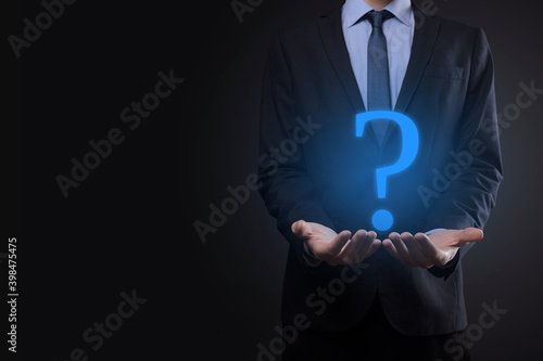 Businessman man hand hold interface question marks sign web. Ask quiestion online, FAQ concept, what where when how and why, search information on internet