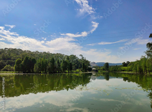 River and trees. Reflections in water.  Southern China Botanical Garden. Guangzhou. Guangdong. China. Asia.	