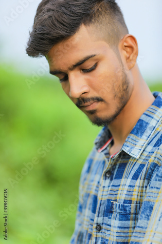 Young indian man showing expression over nature background