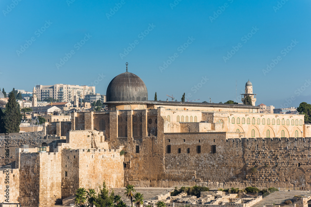 Siliver dome of Al-Aqsa Mosque, built on top of the Temple Mount, known as Haram esh-Sharif in Islam and wall of old city of Jerusalem, Israel. View from Mount of Olives.
