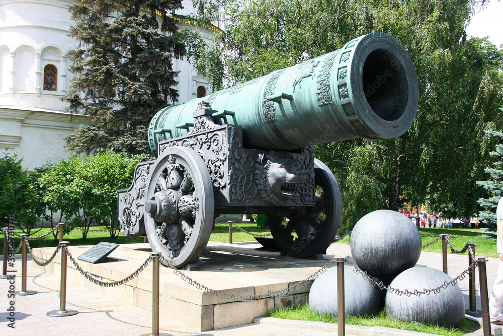 Inside Kremlin's wall. Massive Tsar cannon (pushka) in Cathedral Square, Moscow, Russia. Large early modern period artillery piece, never used in war. Symbol of evil power. Popular travel destination.