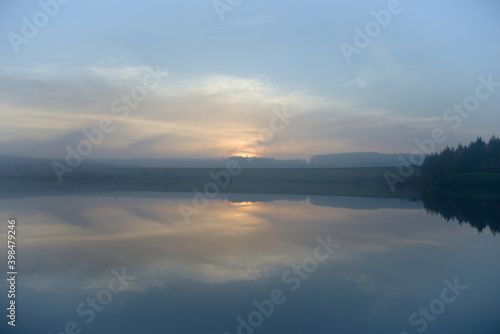 Abstract background landscape image of sunset over water at dusk. © Rhys