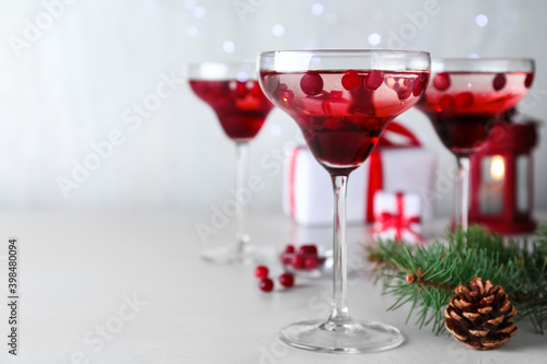 Delicious Christmas cocktail with liqueur on white table. Space for text