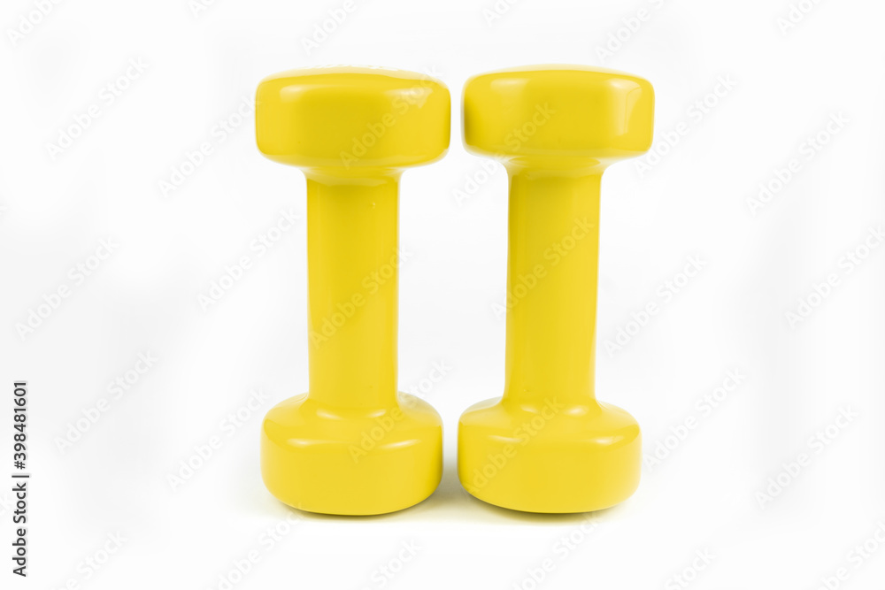 Two yellow dumbbells on white background