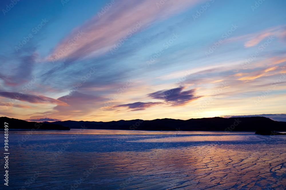 Obraz premium Beautiful sunrise on the frozen lake Baikal. Winter landscape in Russia. 