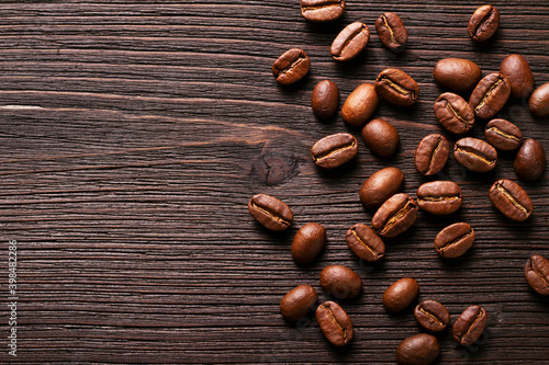 Aromatic coffee Beans on a wooden table with copy space. Rustic style
