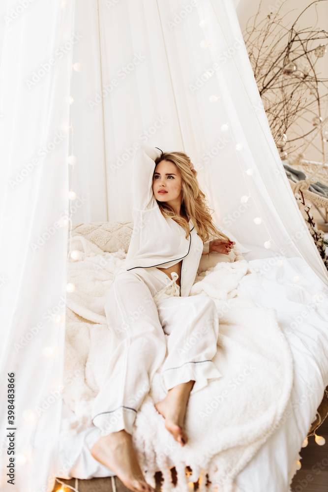 Stylish lady laying in canopy bed, smiling, relaxing, adorable woman chilling, enjoy weekends, spend winter holidays at home, New Year celebration, Christmas morning concept Stylish lady laying in canopy bed, smiling, relaxing, adorable woman chilling, enjoy weekends, spend winter holidays at home, New Year celebration, Christmas morning concept