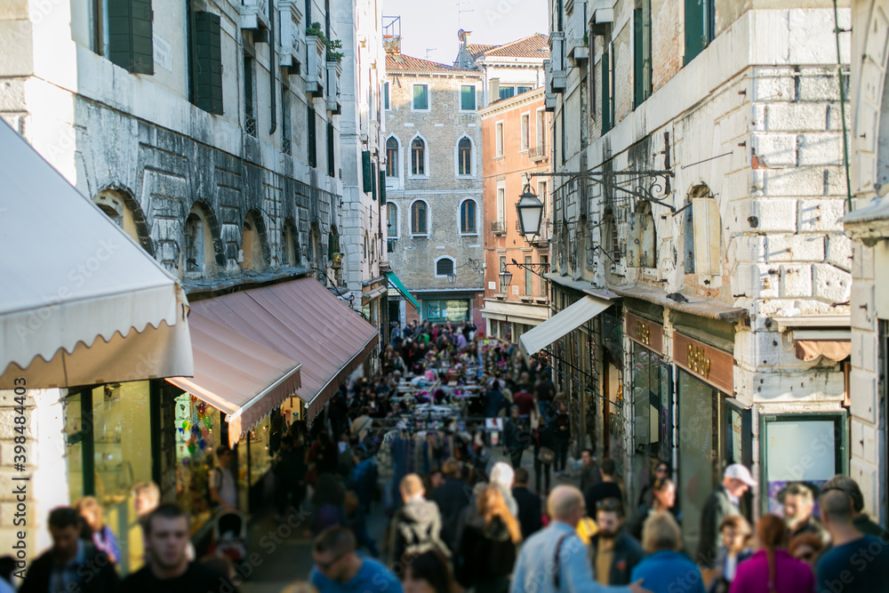 A view of Venice street filled with tourists (faceless, unrecognizable), busy during holidays