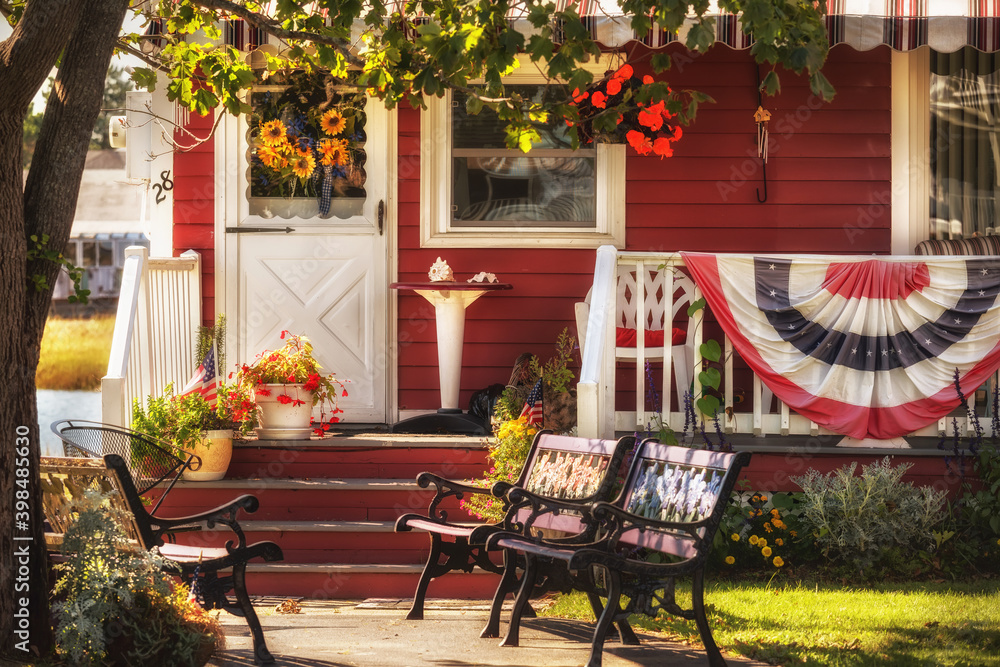The veranda of a traditional American house is decorated with US decorations.
