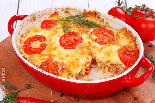 A dish of zucchini  baked with tomatoes and cheese