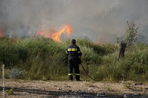 2017. LESBOS, GREECE. The firebrigade in Lesbos is trying to extinguish a fire with the help of volunteers and airplanes. photo