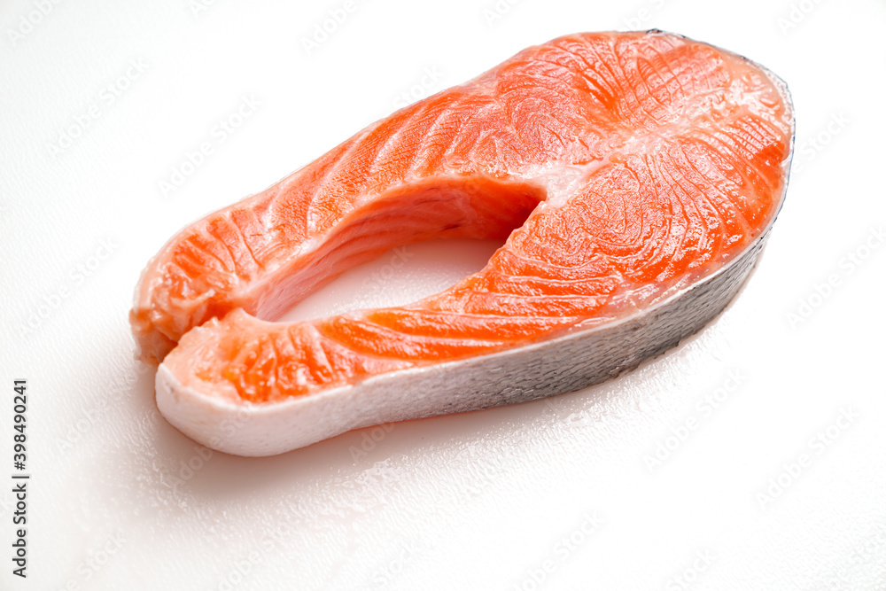 salmon sliced into pieces on white background. red fish. fresh trout for cooking. salmon sliced into pieces on white background. red fish. fresh trout for cooking.