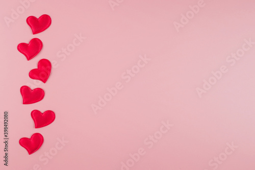 Valentine's day concept with hearts on a pink background. Flat lay, copy space