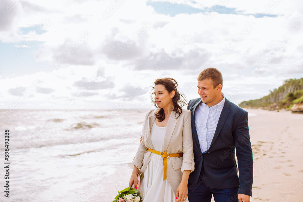 Happy just married middle age couple walk at beach and have fun on summer day.