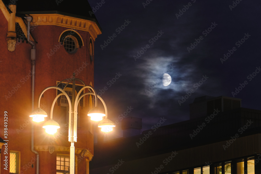 Night cityscape in an Old European City with the moon through the clouds, Helsinki, Finland.