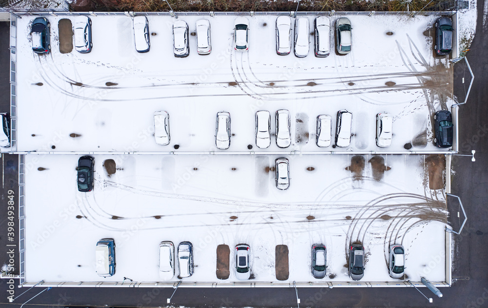 Aerial view of the car parking during the first snowfall this winter.