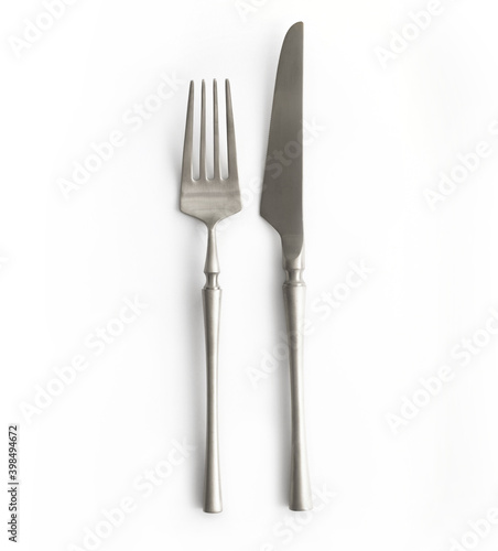 Silver or steel cutlery view from above on a white background. Top view..Knife and fork for a festive table for a wedding, birthday or party.
