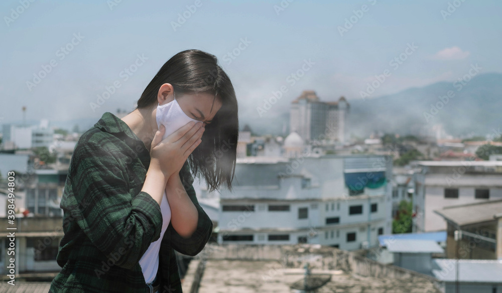 Woman coughing.Woman wearing face mask because of air pollution in the city