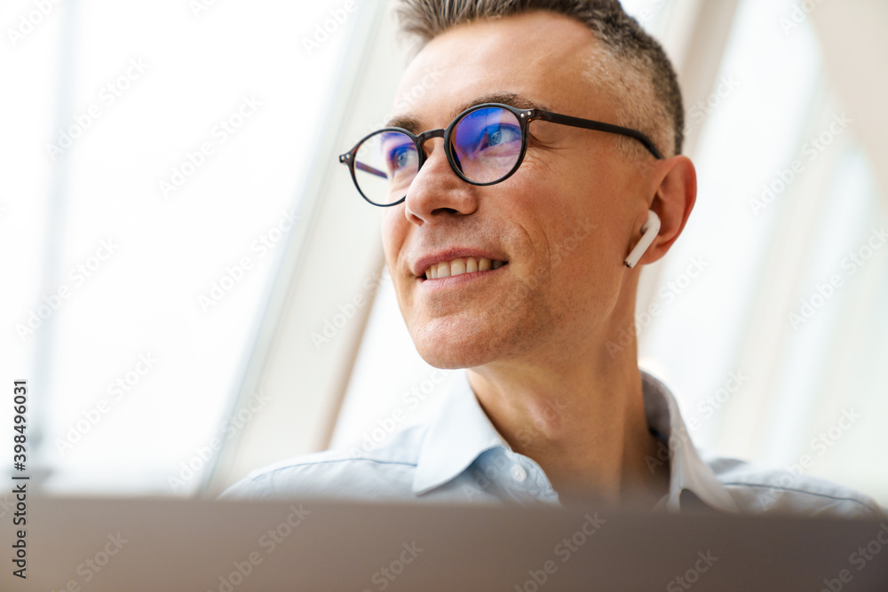 Close up of a smiling businessman sitting Close up of a smiling businessman sitting