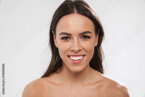 Beautiful shirtless happy girl smiling and looking at camera