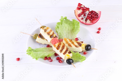 Halloumi skewers on a stick on a white background
