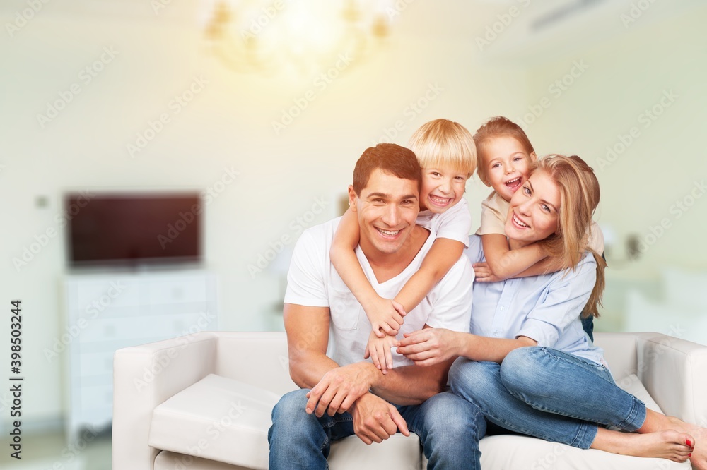 Beautiful smiling lovely family sitting on sofa Beautiful smiling lovely family sitting on sofa