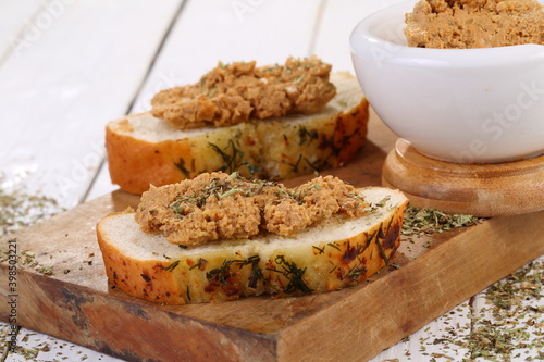 Norwegian cheese brunost on white wooden table