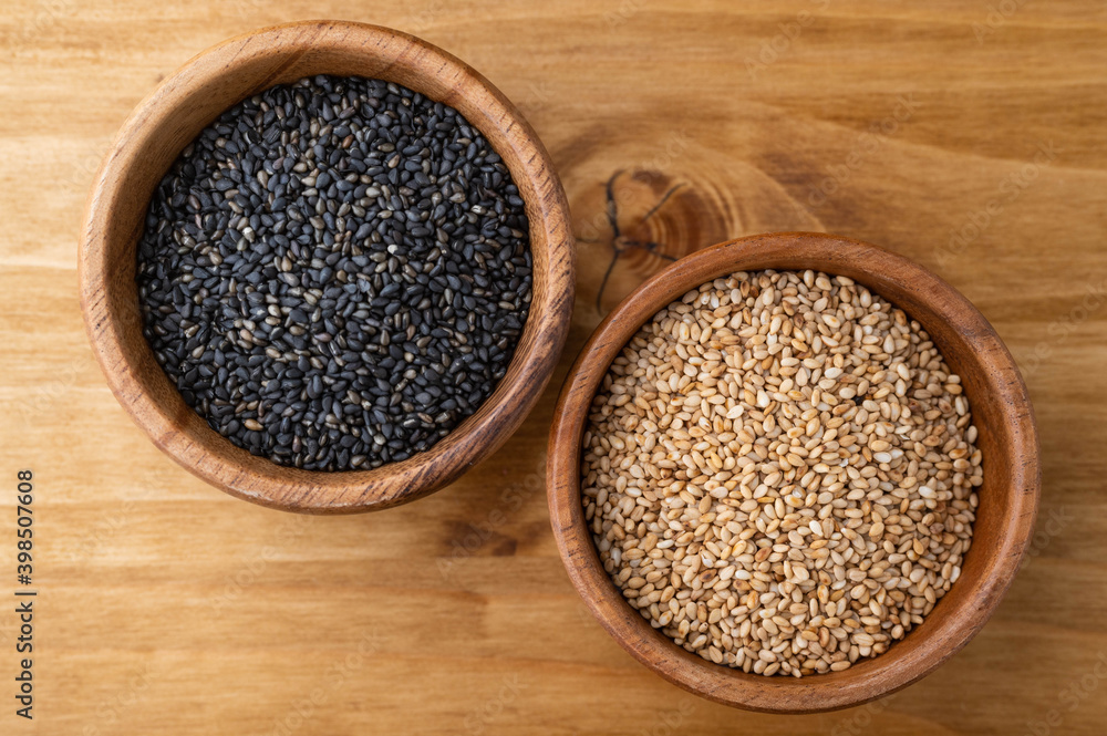 black and wihite sesame in wooden plate black and wihite sesame in wooden plate