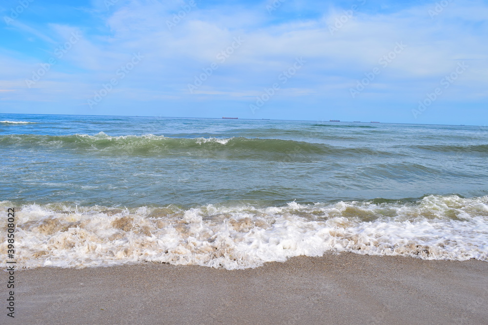 Sea view with cargo ships floating in the distance. Sea view with cargo ships floating in the distance.