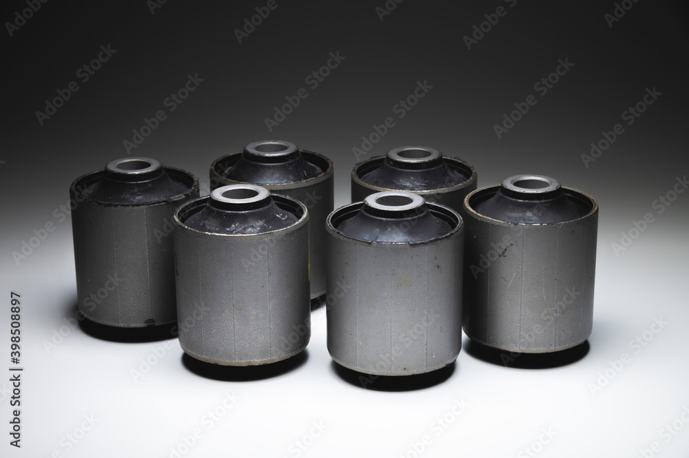 Close-up. A group of cylindrical silent blocks for the rear suspension of an off-road vehicle. Contrast light low key Close-up. A group of cylindrical silent blocks for the rear suspension of an off-road vehicle. Contrast light low key