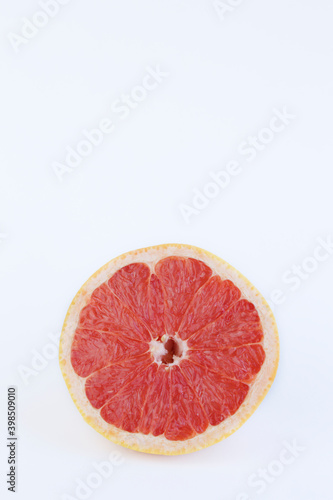 Half grapefruit against white background with copy space