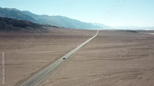 Tracking Aerial Shot Of A Car Driving On Badwater Road In Death Valley National Park