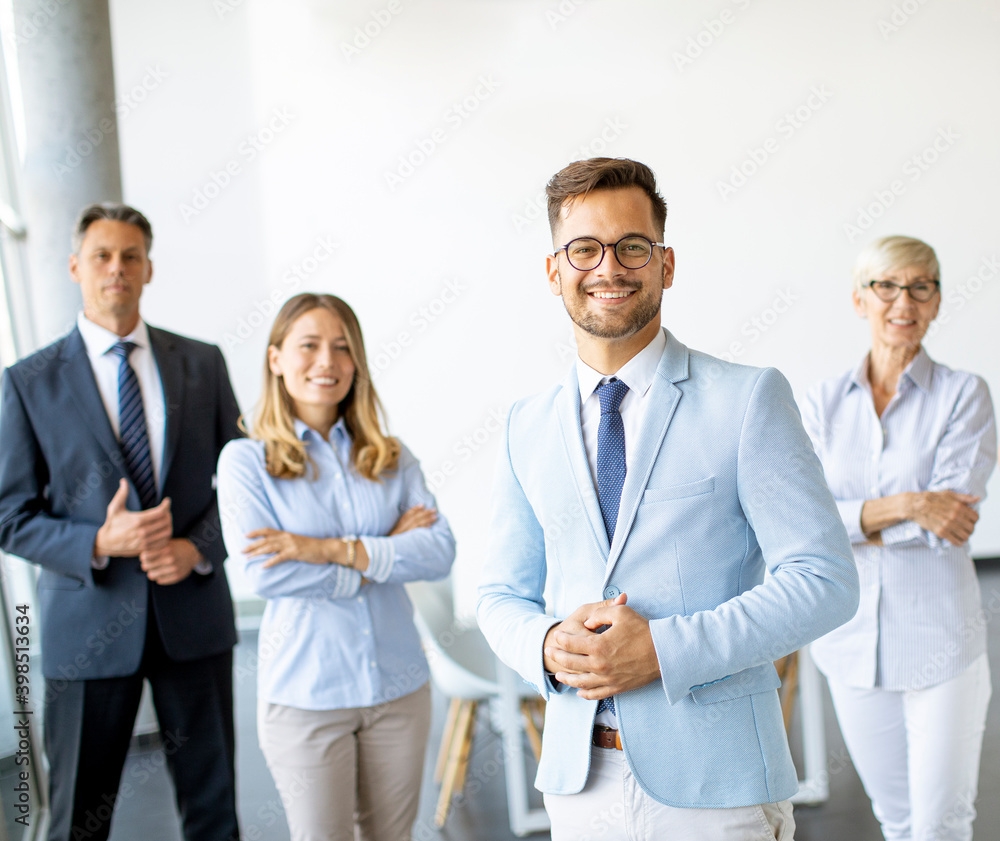 Group of a businesspeople standing together in the office Group of a businesspeople standing together in the office