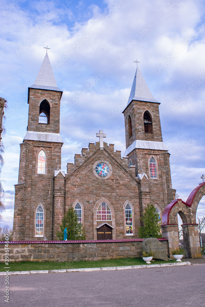 Fototapeta premium A stone church against a blue sky. Church of St. Joseph in the village of Rubezhevichi, Belarus