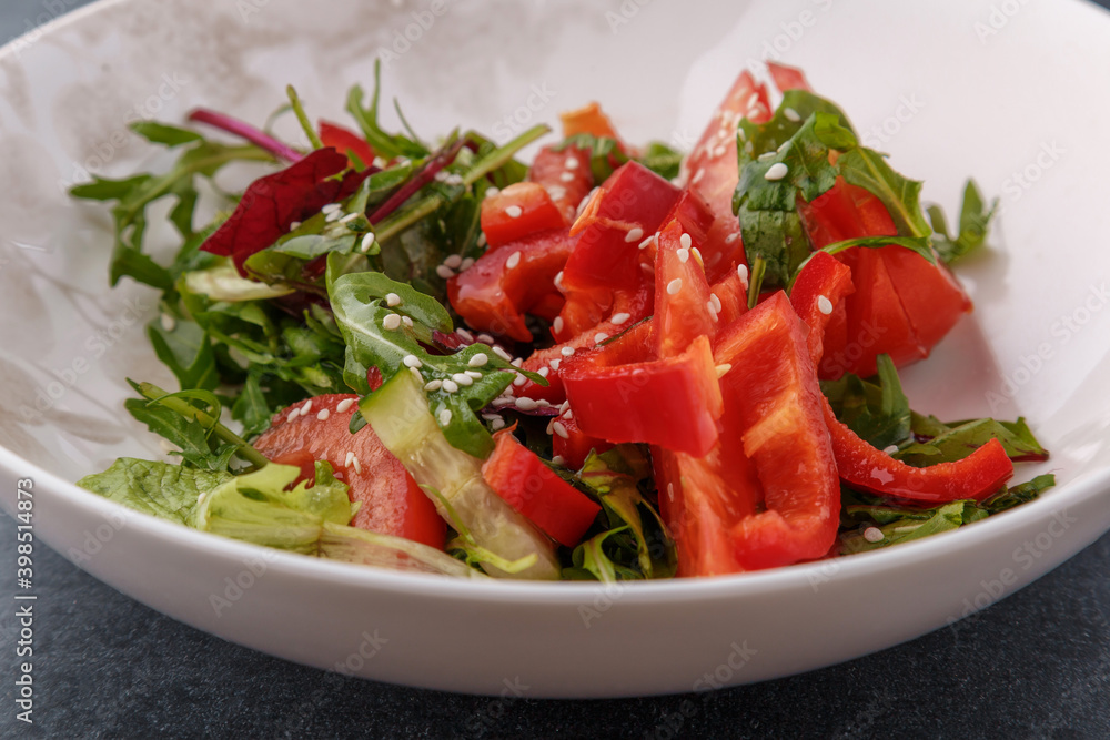 Vegan Spring Salad. Tomato, lettuce, dressing, bell peppers and avocados. Fork with vegetables and salad. Vegan Spring Salad. Tomato, lettuce, dressing, bell peppers and avocados. Fork with vegetables and salad.
