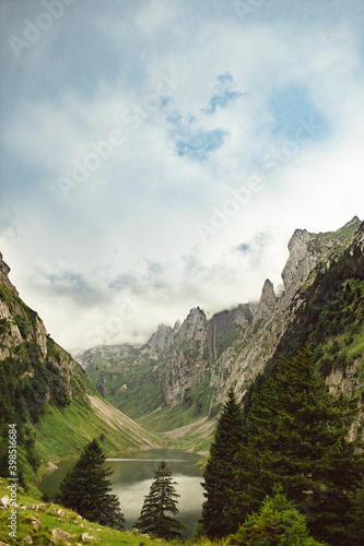 Swiss alpine lake, lake high in the mountains, between two cliffs, cloudy dramatic sky © Mārcis