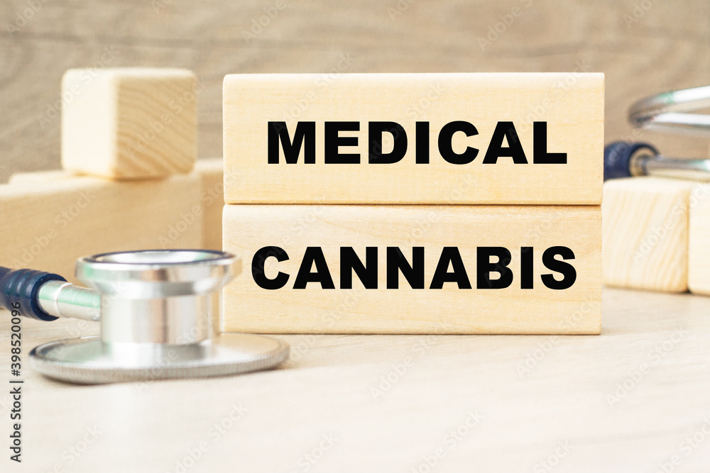the word MEDICAL CANNABIS is written on a wooden cubes structure . Cube on a bright background. Can be used for Medical concept. the medicine. the word MEDICAL CANNABIS is written on a wooden cubes structure . Cube on a bright background. Can be used for Medical concept. the medicine.