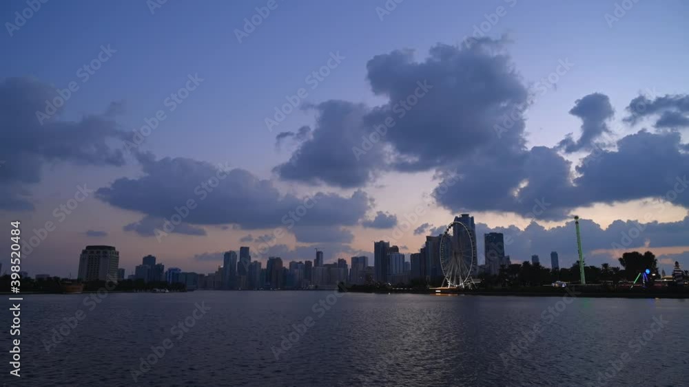 UAE-Dec 2020: Timelapse of the grey clouds floating above the downtown buildings of Khalid Lagoon, Sharjah, United Arab Emirate. 4k Footage UAE-Dec 2020: Timelapse of the grey clouds floating above the downtown buildings of Khalid Lagoon, Sharjah, United Arab Emirate. 4k Footage