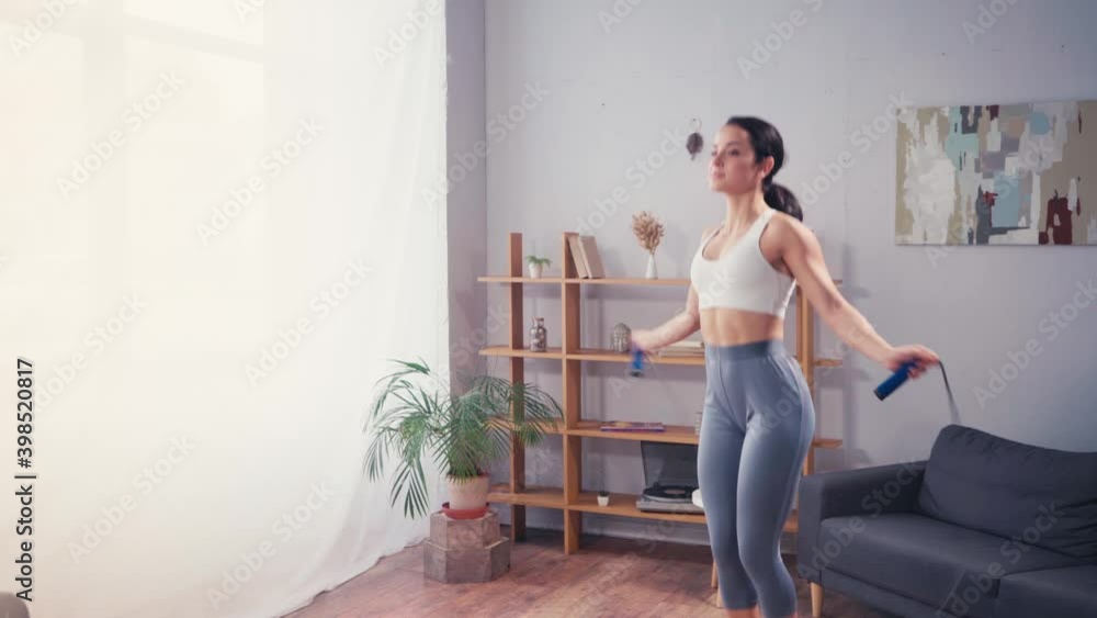 Sportswoman training with skipping rope at home Sportswoman training with skipping rope at home
