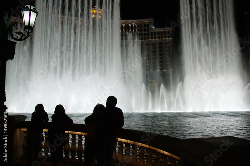 Tourists watching Belagio Fountain Spectacular show at night in Las Vegas photo
