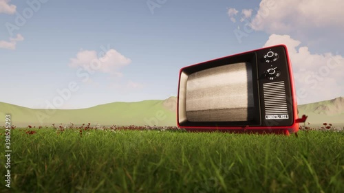 Vintage TV set in the middle of the field 