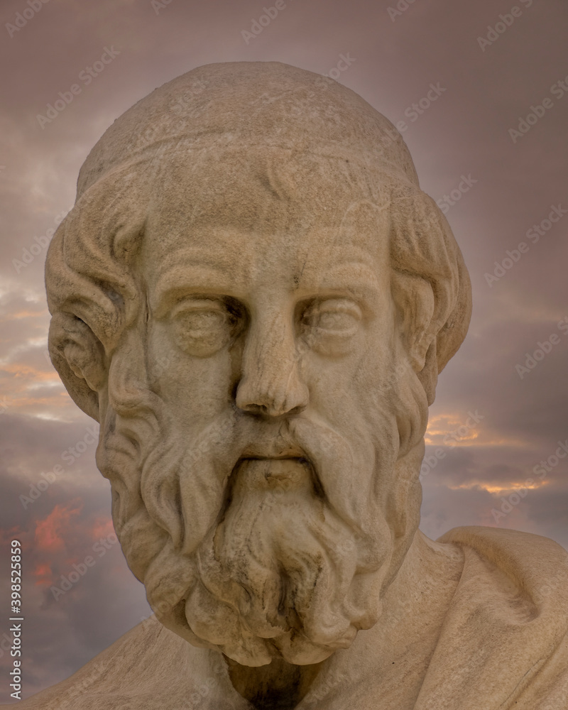 Plato the ancient Greek philosopher statue under dramatic sky, Athens Greece.